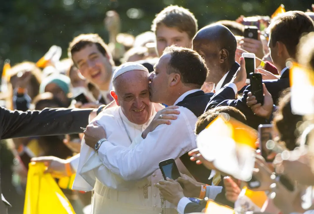 The Heights School teacher Jeff Thompson kisses Pope Francis
