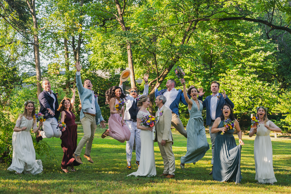 People jumping around the couple