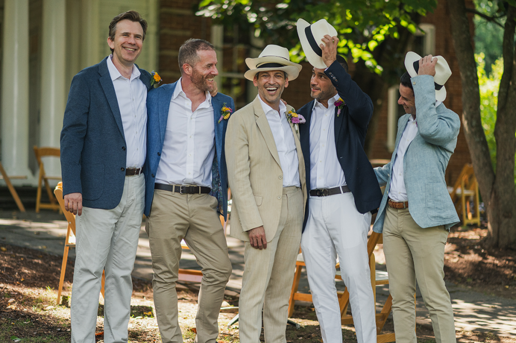 Five people wearing hats and posing for a photo