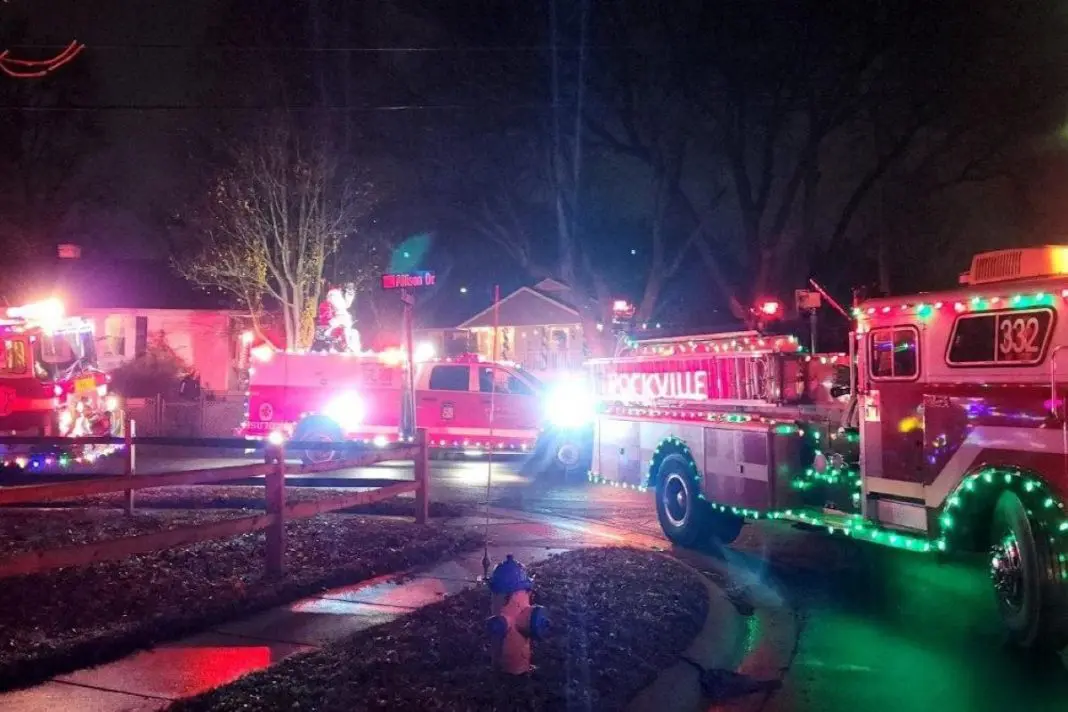 Firetrucks take Santa Claus around a neighborhood