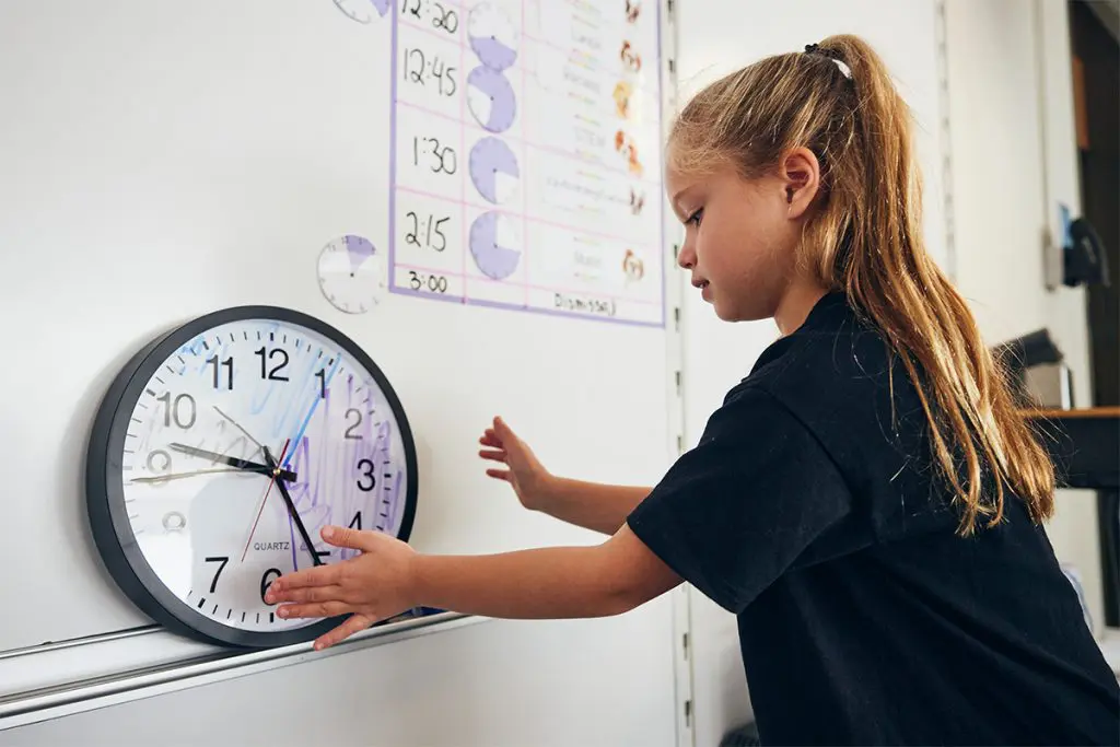 Child looking at a clock