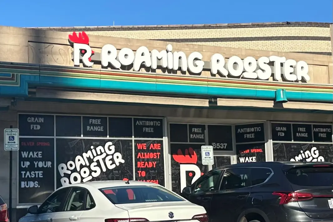 Beige building with a white sign that reads 