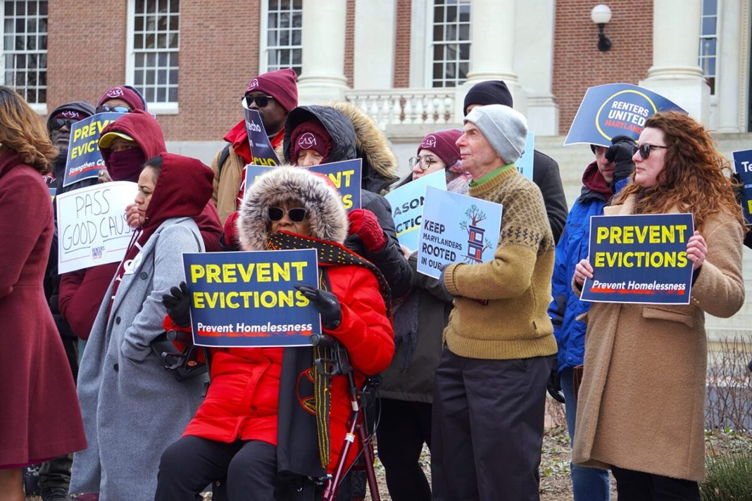 People holding signs saying 