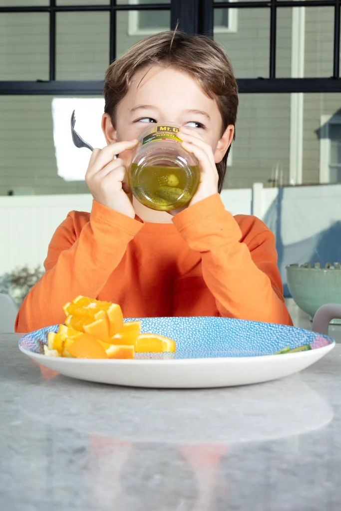 A child drinking pickle juice